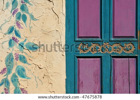 Purple and blue door with stucco wall