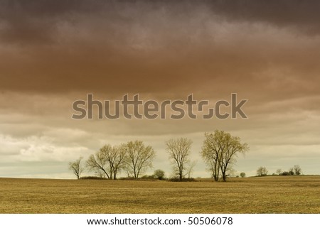 Dark storm clouds over rural landscape