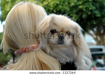 two blond ladies-blond lady with a blond pekingese dog on her shoulder
