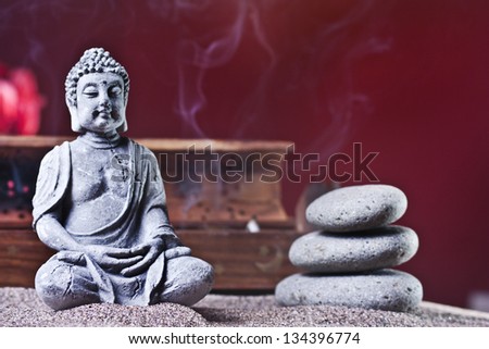 three stone tower and stone sitting buddha