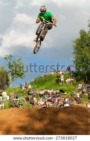 Moscow, Russia, June 06. Biker is making stunt at his mountain bike at Pit Jam contest, June 06, 2011 in Moscow, Russia