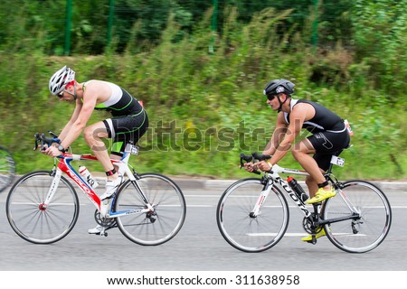 Moscow, Russia, August 16. Two triathletes ride speed cycles during triathlon competition in Moscow, August 16, 2015 in Moscow, Russia