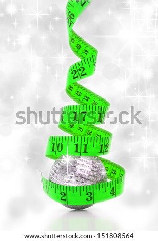 Christmas diet concept represented by a Christmas tree made from a measure tape