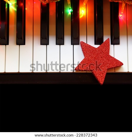Christmas lights and ornament on piano keys