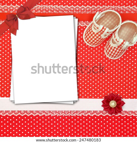 Baby shoes and paper cards on polka dots background