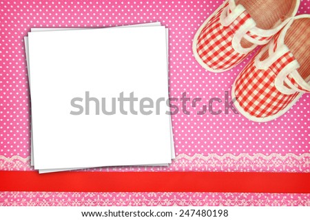 Baby shoes and blank cards on polka dots background