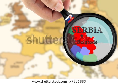 Magnifying glass over a map of Serbia