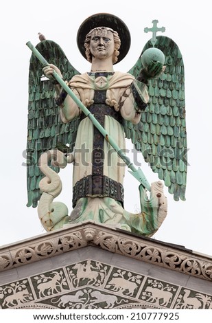 The 4 m-tall statue of St. Michael the Archangel on top of the San Michele in Foro, the Roman Catholic basilica church in Lucca, Tuscany, central Italy