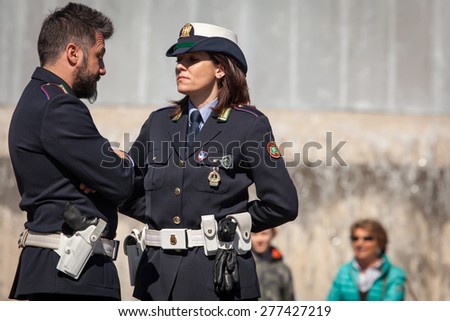 MILAN, ITALY - APRIL 7 2015: Italian municipal police deals mainly with local traffic control and municipal administration. They wear white helmets and dress in black in winter and blue in summer.
