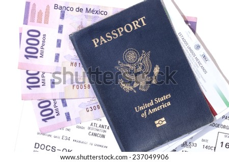 Closeup of American passport, pesos, boarding pass and tourist card for traveling to Mexico