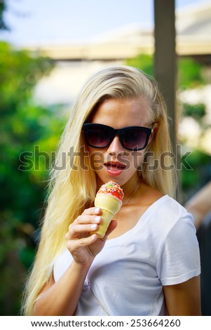 Sexy young blonde woman eat an ice cream.
