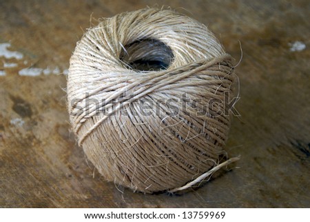 Rough garden string in a ball on a concrete floor