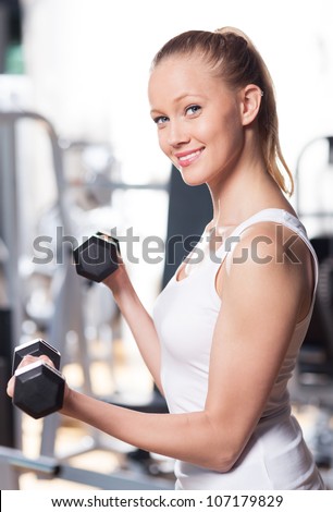 Woman exercising with dumbbells