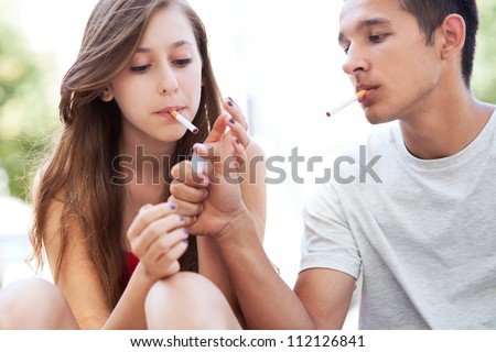 Similar – Foto Bild Teenager-Mädchen mit Rauchzeichen am Strand