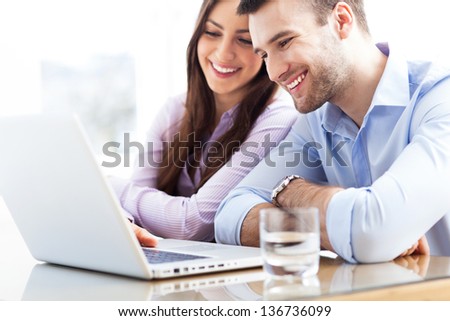 Business couple using laptop