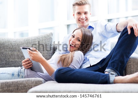 Similar – Image, Stock Photo Carefree couple resting on hill near sea