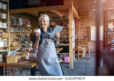 Similar – Image, Stock Photo Senior craftswoman with tablet computer in art studio