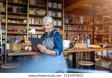 Similar – Image, Stock Photo Senior craftswoman with tablet computer in art studio