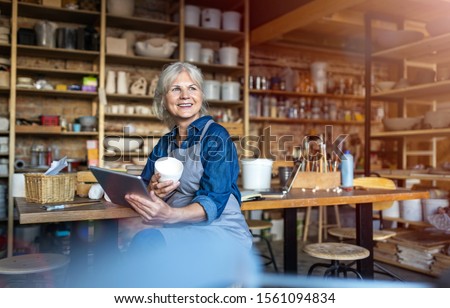 Similar – Image, Stock Photo Senior craftswoman with tablet computer in art studio