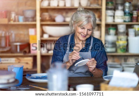 Similar – Image, Stock Photo Senior craftswoman in art studio