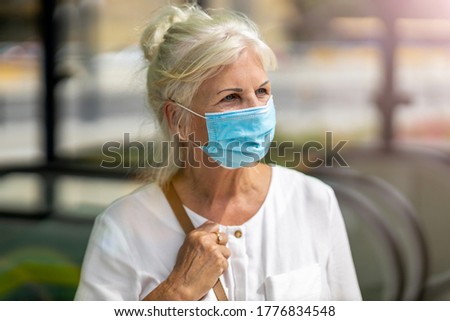 Similar – Image, Stock Photo old woman wearing protective mask holding hands with unrecognizable woman. New normal concept