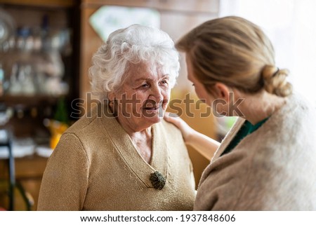 Health visitor talking to a senior woman during home visit
 Foto d'archivio © 