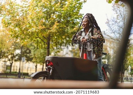 Image, Stock Photo Woman using cargo bike in urban area