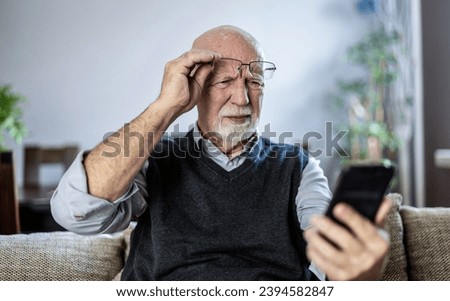 Similar – Foto Bild Mann schaut auf der Straße auf sein Telefon.