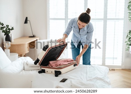 Similar – Image, Stock Photo A young woman leaving the airport with her luggage at her destination
