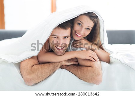 Couple under bed covers