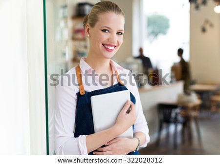 Proud young female cafe owner