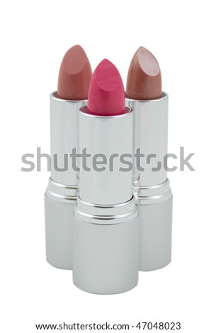 Three multicolored lipsticks in metallic tubes isolated over white background