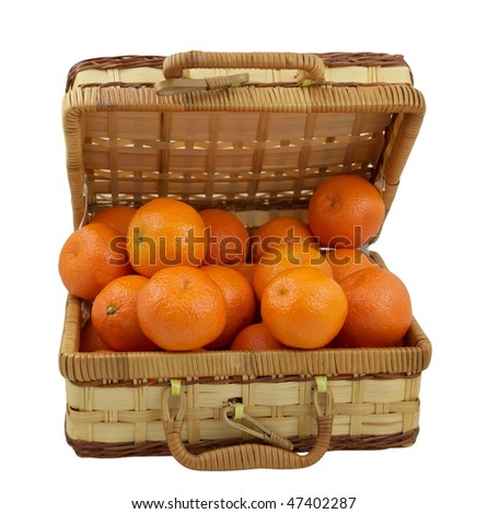 Juicy tangerines in the wicker box isolated on white background