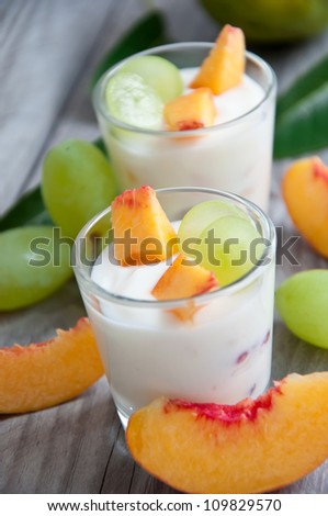 Fresh peach and grape yogurt in glass