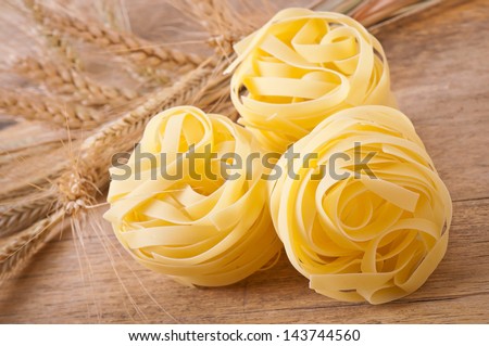 pasta and wheat ears on the wooden table