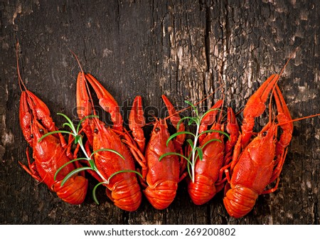 Boiled crawfish on a wooden background. Top view