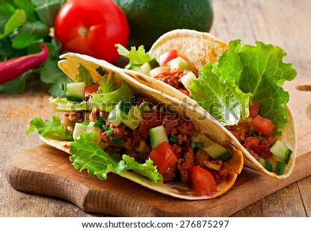 Mexican tacos with meat, vegetables and cheese