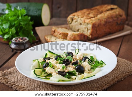 Zucchini salad with feta, olives and pine nuts
