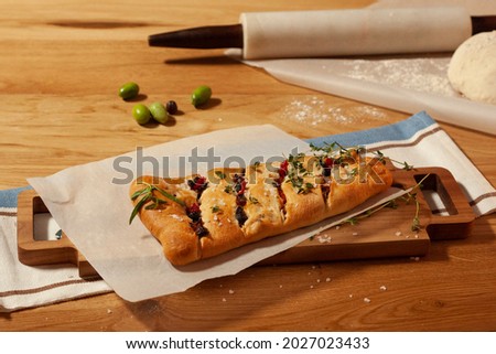 hot mini piza ready on baking paper with bakery background containing olives, dough, flour, roller Сток-фото © 