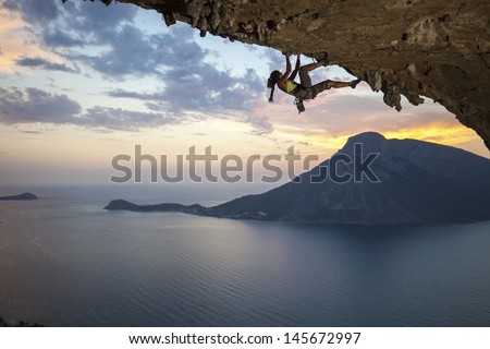 Young female rock climber at sunset, Kalymnos Island, Greece