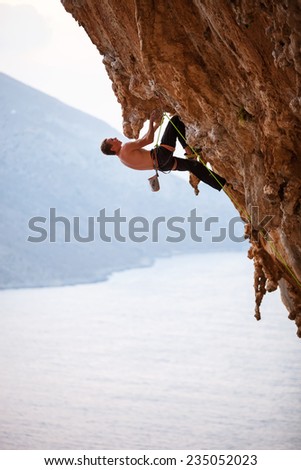 Rock climber on overhanging cliff