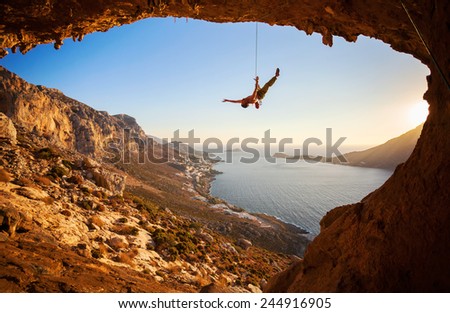 Rock climber hanging on rope while lead climbing