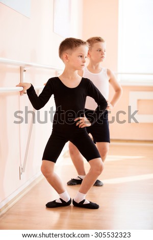 Young boys working at the barre in a ballet dance class.