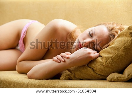 Young pretty blond woman sleeping on couch