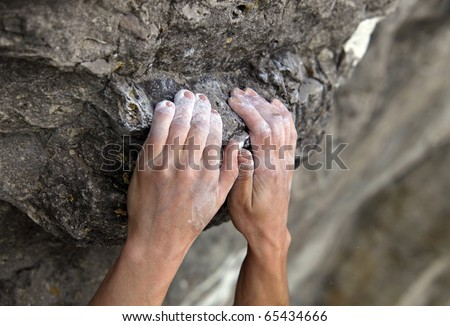 Rock climber's hands on handhold