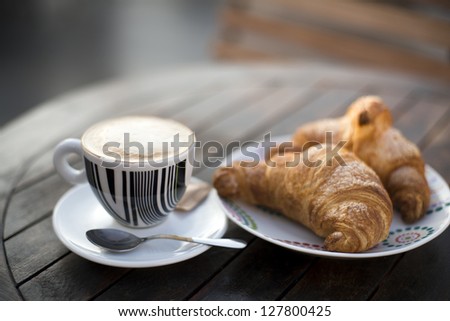 Fresh Cappuccino and croissant close up shoot