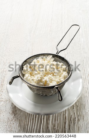 Making Fresh cottage cheese on wooden background