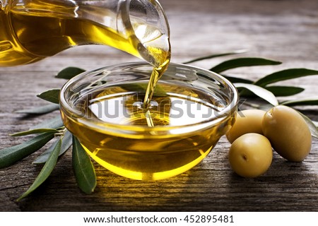 Bottle pouring virgin olive oil in a bowl close up ストックフォト © 