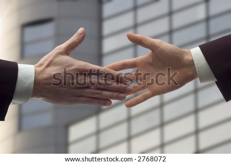 business handshake over blurry background