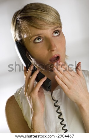 young women shocked talking on the phone